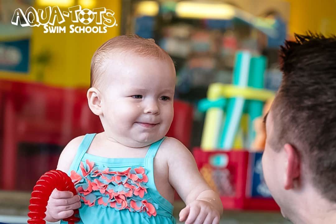 Aqua-Tots Swim Schools parent and toddler class with father and baby. 