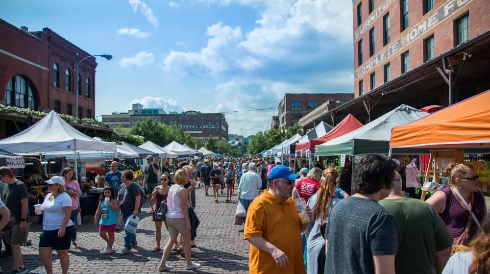 Old Market Farmers Market bustling with vendors and people. 