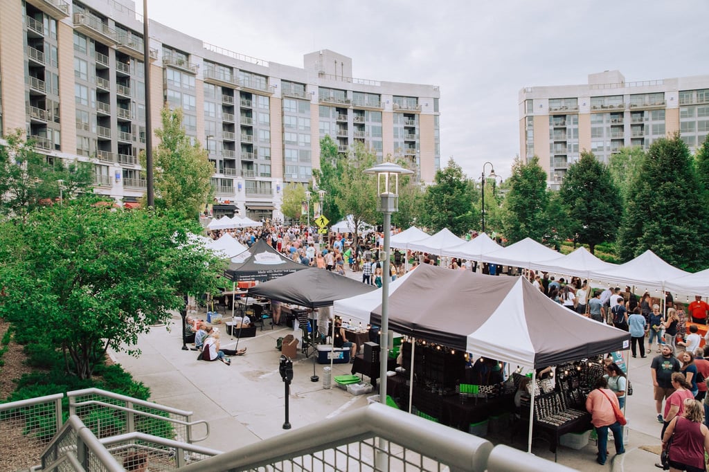 Market stalls bustling with people at the Turner Park Night Market at Midtown Crossing. 